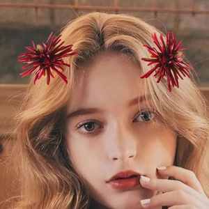 Red flower hair clips featuring layered silk petals for women shown on a model