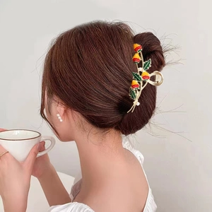 Elegant strawberry alloy hair claw clip for women shown in a realistic hairstyle setting
