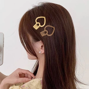 Driedelige set hartvormige metalen haarclips in goud- en roségoudkleurige afwerking