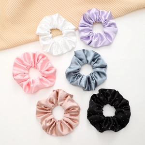 Detailed view of six-piece satin scrunchies with silver rhinestones in varied colors