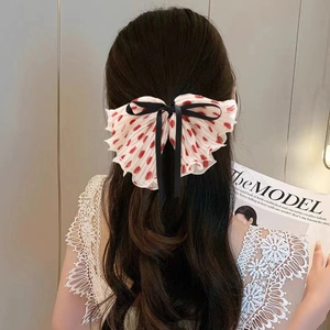 Polka dot bow hair clip in cream and red, oversized chiffon design for elegant hairstyles
