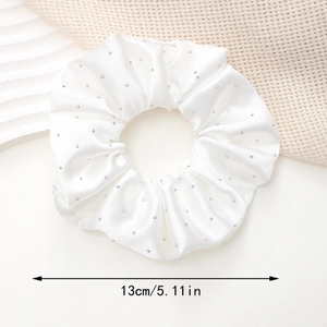 Close-up of white satin scrunchie with rhinestones showing 13cm diameter detail