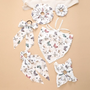 Detail view of lace butterfly hair accessories and triangle scarf set for women