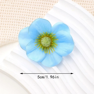 Macro shot of 5cm sky blue fabric flower hair clip with yellow pistil details