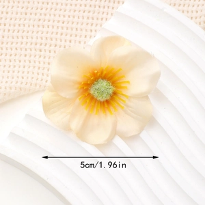 Detailed macro view of 5cm cream orange fabric flower hair clip with realistic stamens