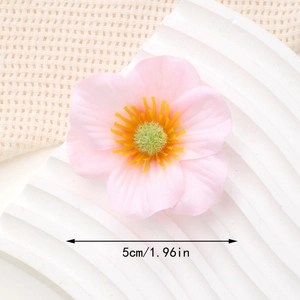 Close-up of pink silk flower head with yellow stamens and a 5cm size measurement mark