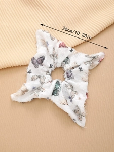 Detail view showing large 26cm white scrunchie with colorful butterfly print and frayed edges