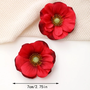 Detailed view of 7cm red fabric silk flower hair clips with realistic yellow stamens