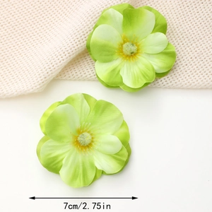 Detailed view of two 7cm green silk flower heads with multi-layered petals and stamens