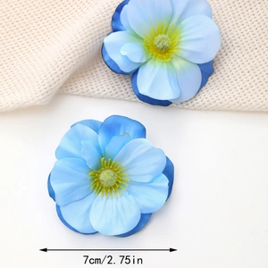 Close-up of blue fabric flower hair clip with 7cm diameter measurement label