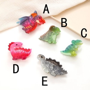 Set di mollette per capelli in acrilico a forma di dinosauro con vari stili colorati