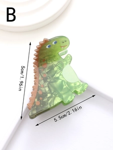 Dettaglio della molletta per capelli a dinosauro verde con texture marmorizzata
