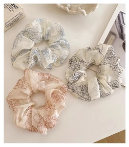 Detailed macro shot of vintage floral pattern scrunchies made of soft silk chiffon fabric