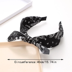 Detail view of paisley print bow headband with 40cm/15.74in circumference measurement