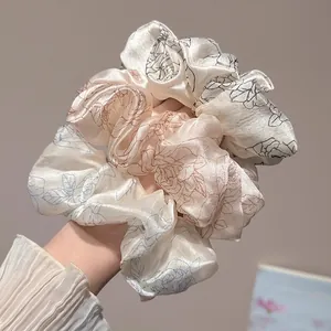 Elegant satin floral scrunchies with retro rose patterns in blue, brown, and black colors