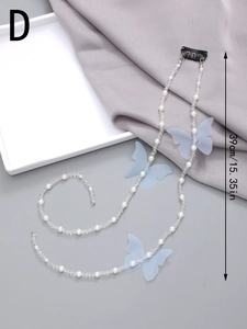 Detail view of 39cm long pearl hair ribbon with blue mesh butterflies and spring clip