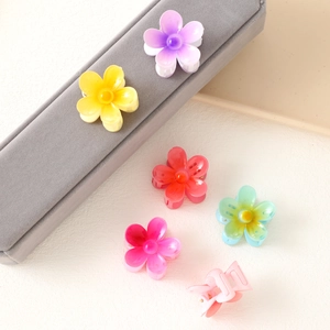 Set of colorful plumeria flower hair claws in vibrant shades for beach vacations