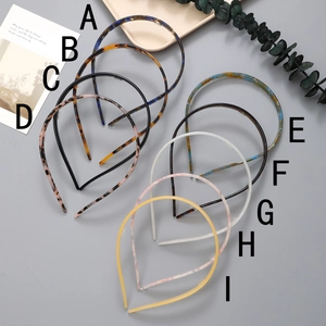 Detail view of 9 acetate headbands with tortoiseshell and marble patterns and non-slip teeth