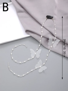 Detail view of a 39cm pearl hair chain with white gauze butterflies and beads