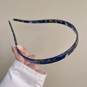 Close-up of slim blue tortoiseshell headband with anti-slip transparent inner teeth