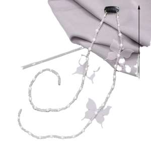 Elegant pearl hair chain with organza butterflies and crystal beads on silk background