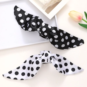 Set of two retro polka dot bow hair clips in black and white satin for daily ponytails