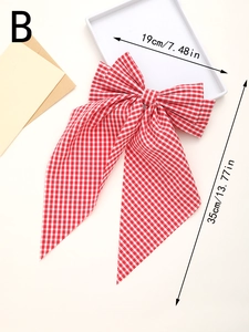 Detail view of red and white plaid bow hair clip with streamers and size measurements