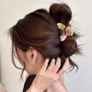 Elegant marble acetate hair claw clip for high ponytail hairstyle on brown hair model