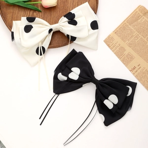 Set of two vintage polka dot bow hair clips with long ribbon tassels in black and white