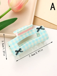 Detailed size view of blue checkered bow hair claw clip measuring 7.4cm long