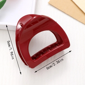 Detailed view of deep red glossy hair claw clip with size dimensions 5cm by 6cm