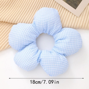Close-up of a 18cm large blue and white checkered 3D flower scrunchie with soft fabric