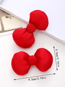Detailed view of red fabric hair bows showing dimensions 9.5cm by 5.5cm for women