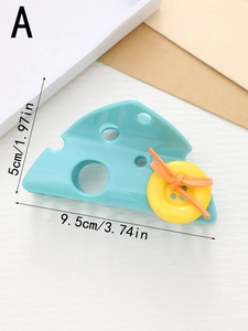 Detail view of light blue cheese hair claw with yellow button and orange suede knot