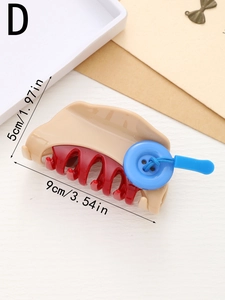Detail view of large hair claw clip with contrast colors and blue button decoration