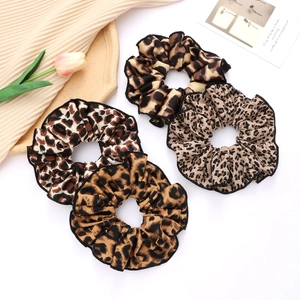Set of leopard print scrunchies in various shades on a minimalist elegant background