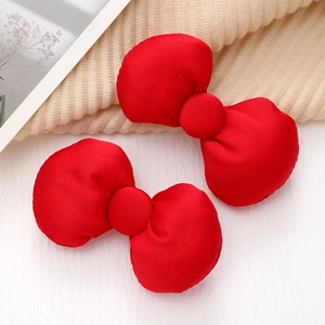 Sweet red fabric bow hair clips for women with a vibrant textured and 3D stuffed design