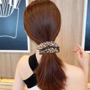 Leopard print scrunchie hair tie shown in a realistic ponytail style for women
