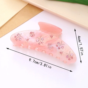 Vue détaillée de la pince à cheveux rose avec strass et dimensions de 9,7 cm