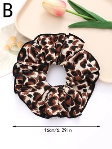 Detailed view of brown leopard print hair scrunchie with 16cm diameter measurement