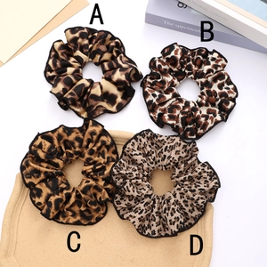 Elegant satin leopard print scrunchies in four stylish patterns for versatile hair styling