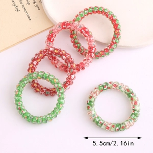 Détail d'élastiques spirale de Noël avec motifs festifs et mesure de 5,5 cm de diamètre