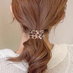 Durable leopard print hair scrunchie shown on model ponytail for stylish hair styling