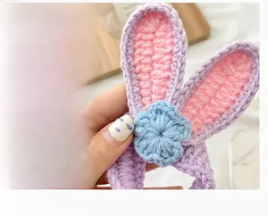 Dettaglio dell'elastico per capelli lavorato a maglia con orecchie di coniglio e fiori