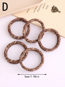 Detail showing five brown leopard print hair ties with a 5cm diameter and elastic texture