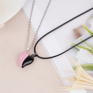 Detail of pink and black heart pendant necklace set with magnetic closure and mixed chains