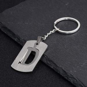 Minimalist stainless steel keychain with letter D cutout on brushed metal plaque