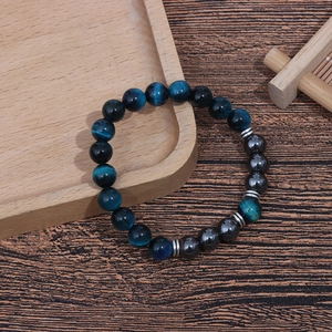 Close-up of 8mm tiger eye beads and hematite spacers on a beaded couple bracelet