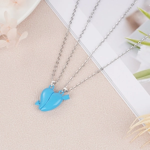 Detail showing magnetic heart pendants with arrow design and sky blue finish on silver chains