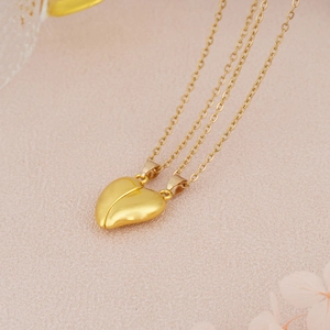 Detail of gold heart magnetic couple necklaces with matching polished heart pendants